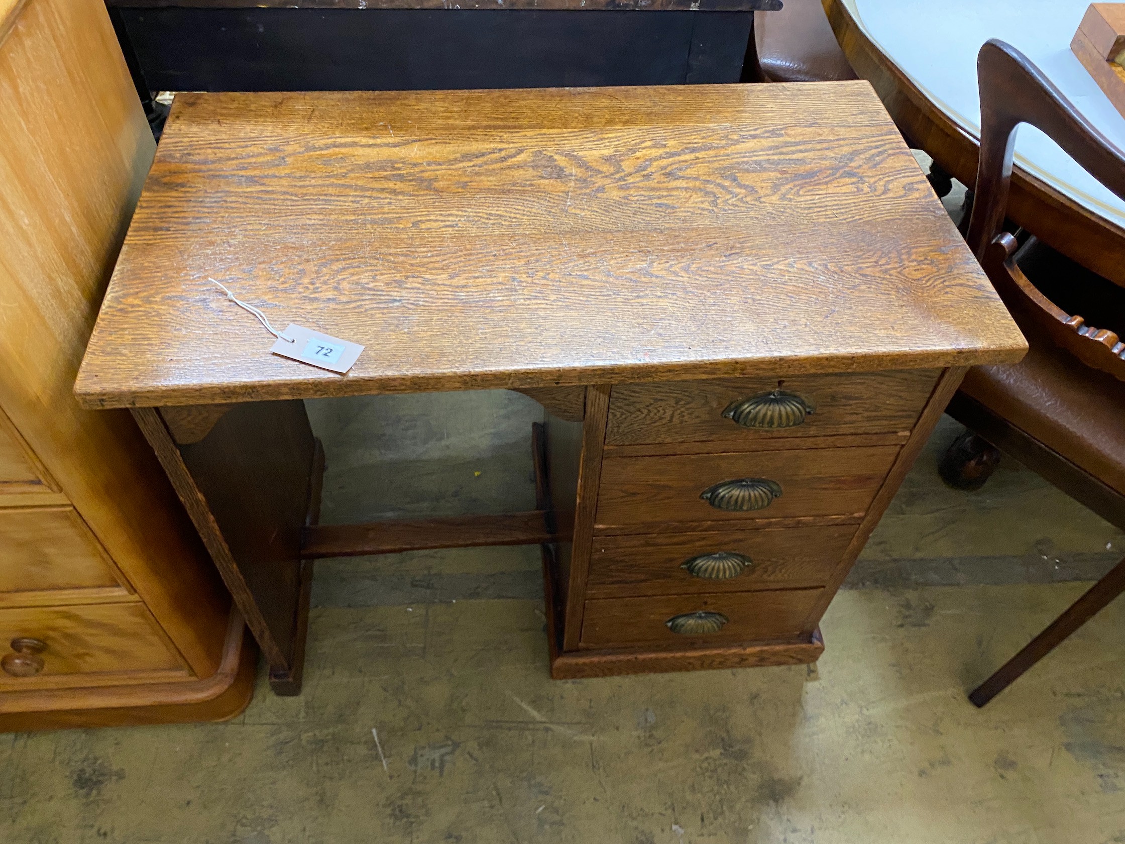 A small 1920's oak four drawer kneehole desk, length 81cm, depth 45cm, height 69cm